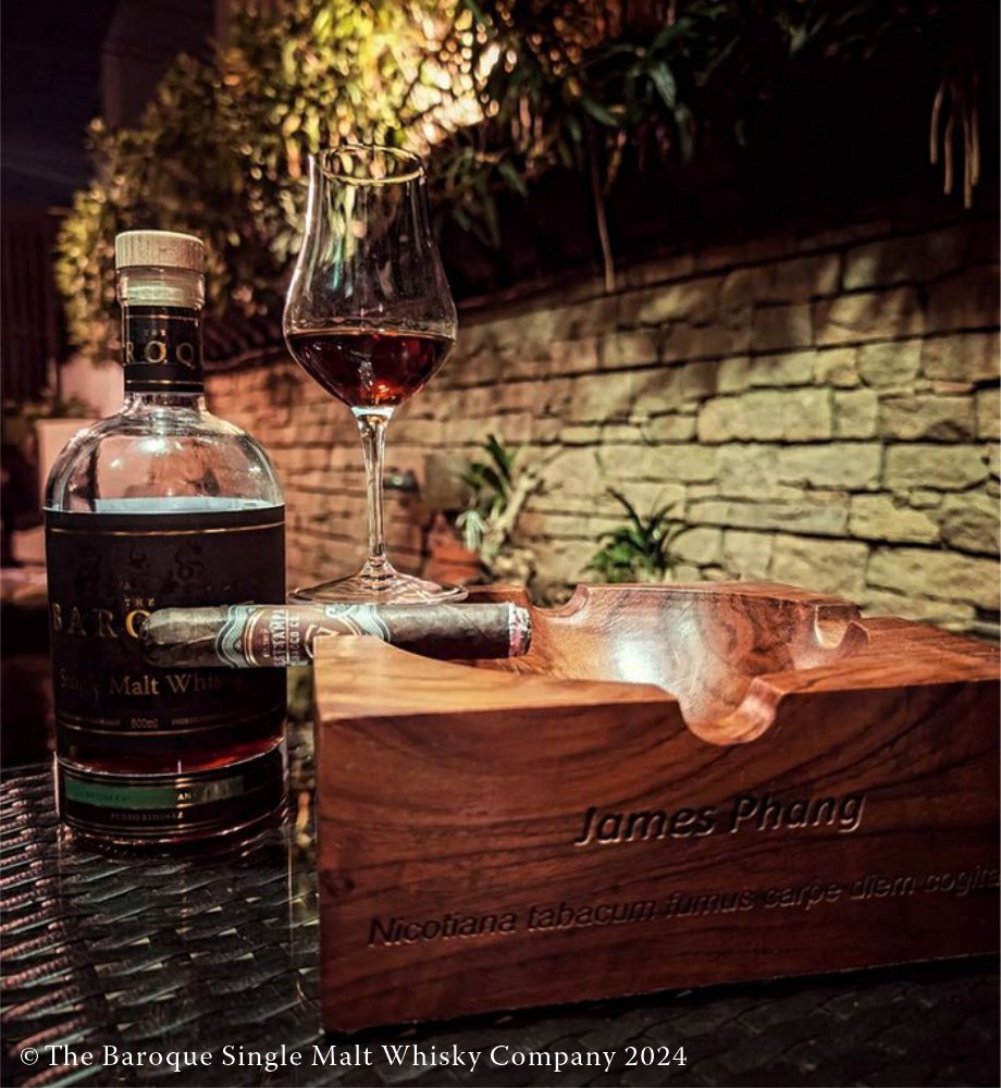 west tampa red cigar on cigar box with bottle of baroque single malt whisky behind